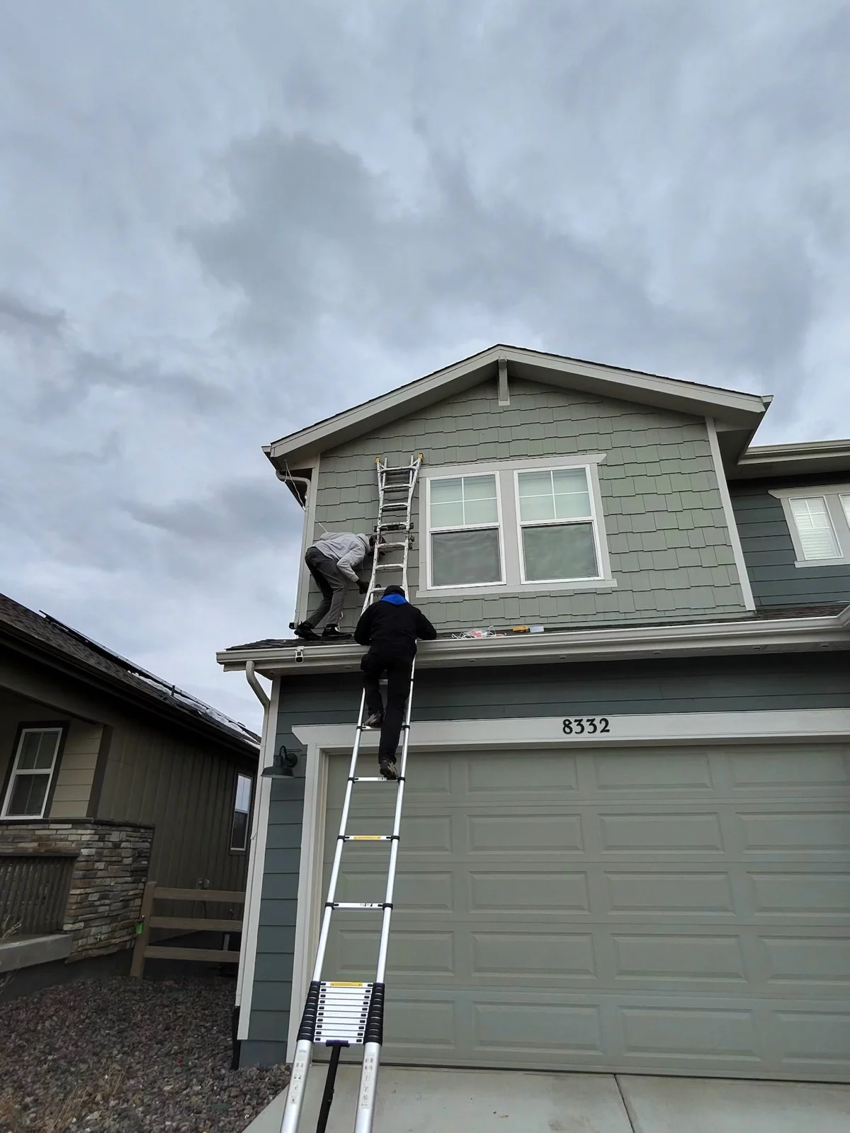 Professional holiday light installation from a ladder