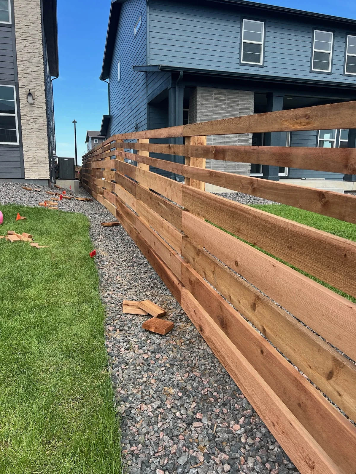 A long run of new horizontal cedar fence between homes